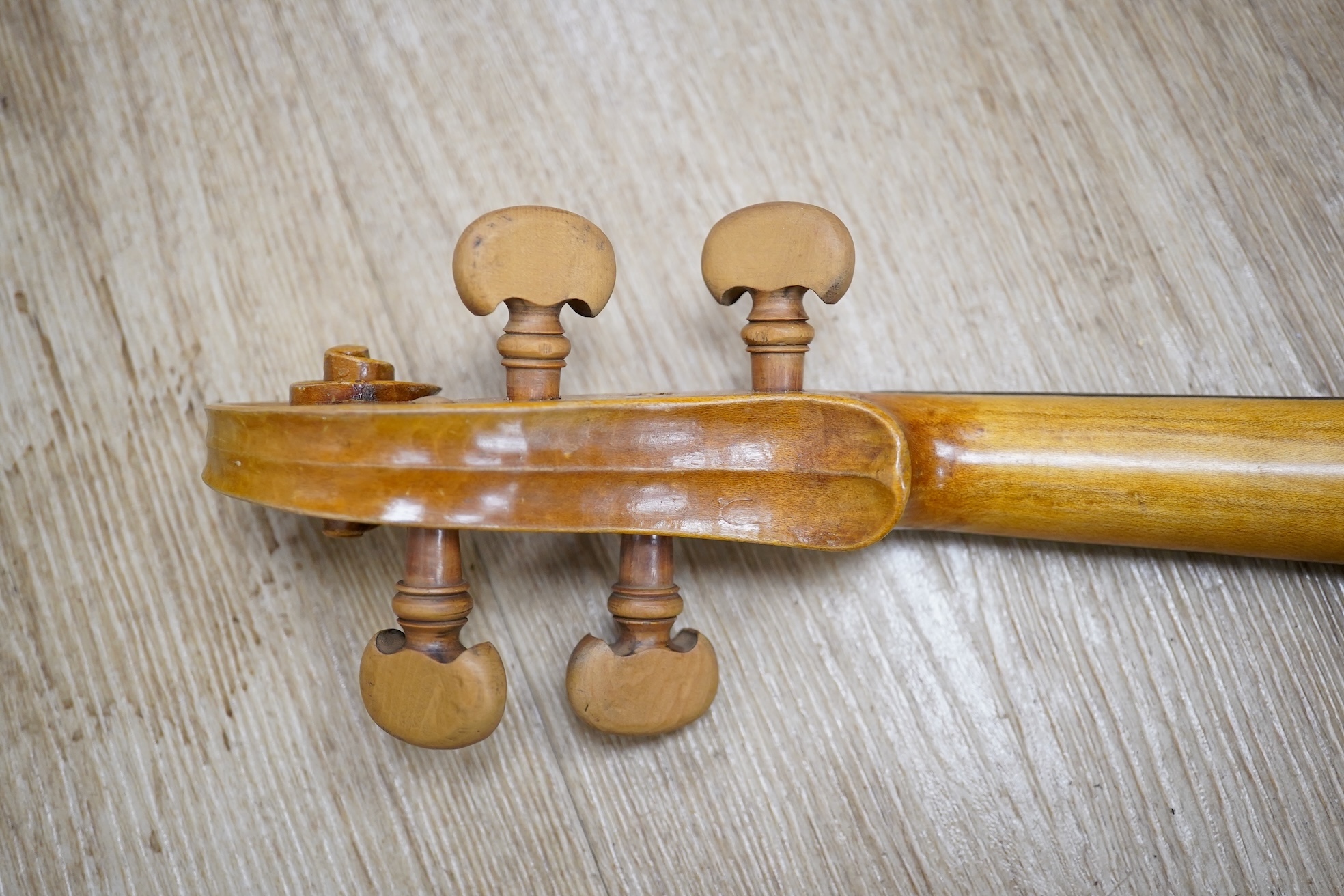 Two cased three quarter size violins, one labelled the London violin Co Ltd, length of back 33.5cm. Condition - both scratched